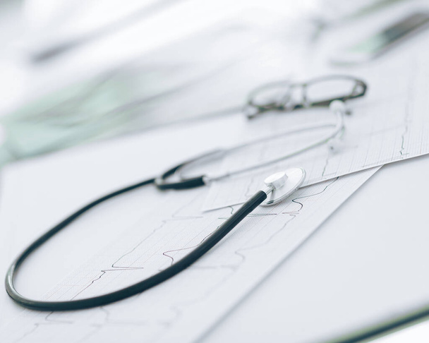 close up. glasses and a stethoscope on the therapists Desk - 写真・画像