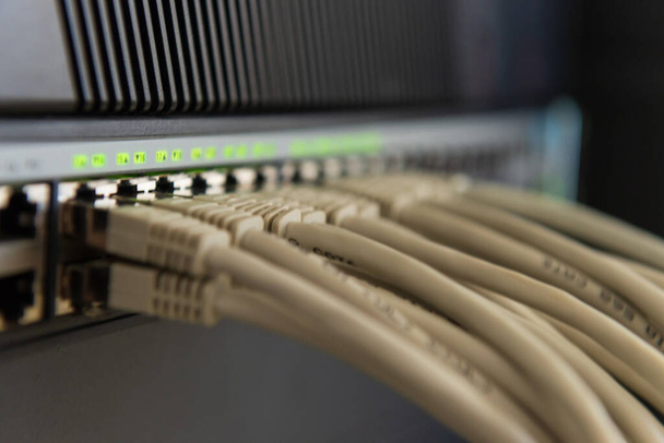 A selective focus shot of ethernet cables connected to switch - Fotó, kép