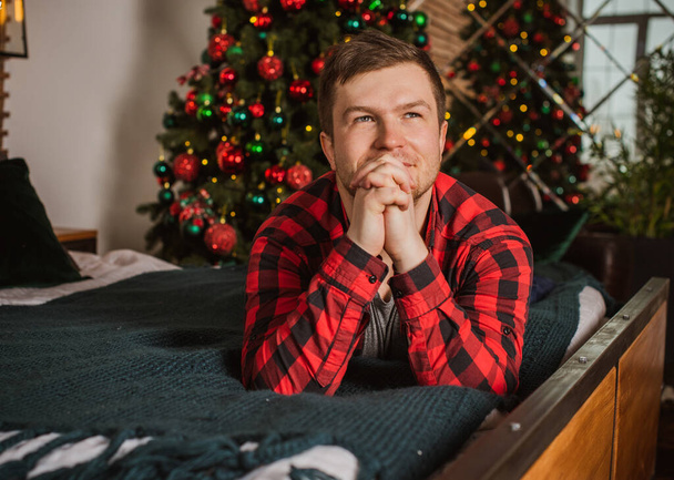 Young plump guy at winter holiday, Christmas time, plus size man at cozy home  - Photo, Image