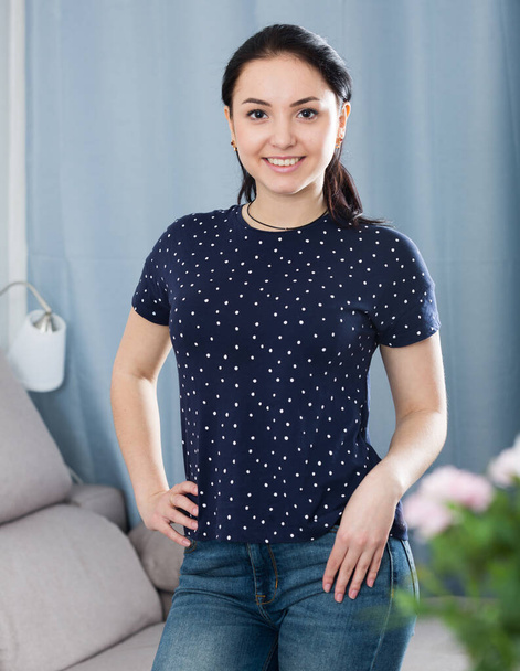 Smiling brunette standing at home - Фото, изображение