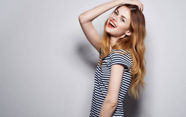 pretty woman in striped t-shirt glamor cosmetics decoration luxury studio model - Foto, Imagem
