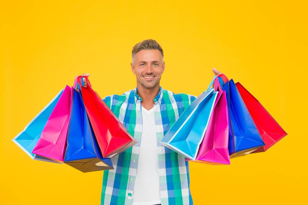 mature happy man carry heavy shopping bags. black friday. male shopper with packages. prepare for holidays. christmas sales and discounts. birthday present packs. shopaholic - Foto, imagen