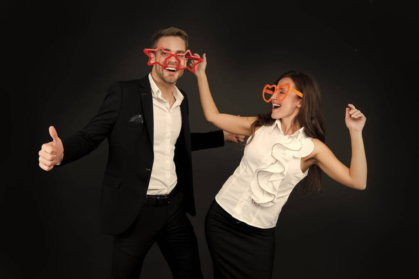 We love fun. Happy couple have fun dark background. Sexy girl and handsome man wear giant fun glasses. Valentines day fun. Holiday celebration. Party and entertainment. Dance and enjoy - Foto, Imagem