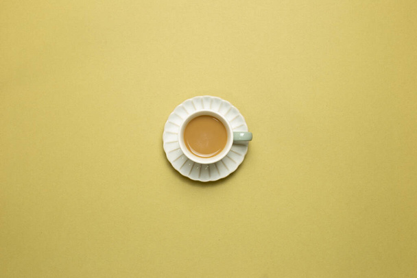Cup of coffee on khaki background. top view, copy space - Φωτογραφία, εικόνα