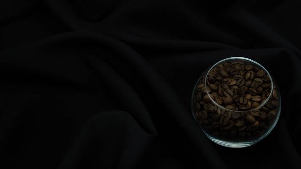 Fragrant, grain coffee in a beautiful transparent container on black background. High quality photo - Φωτογραφία, εικόνα