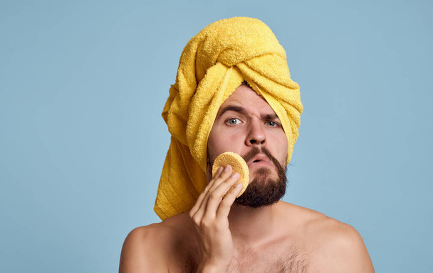 man with towel on head naked shoulders skin care blue background - Fotografie, Obrázek