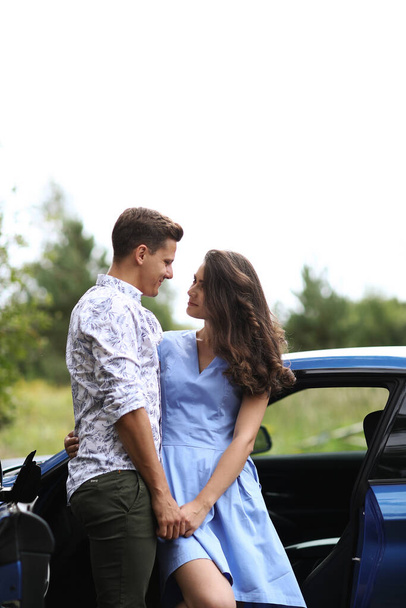 Lovely couple is traveling with a car - Foto, imagen