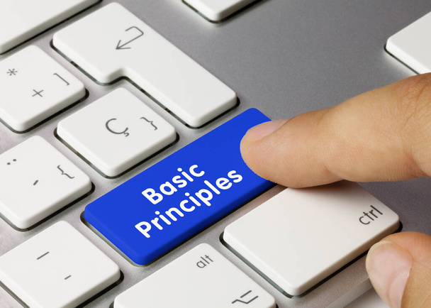 Basic principles Written on Blue Key of Metallic Keyboard. Finger pressing key. - Photo, Image
