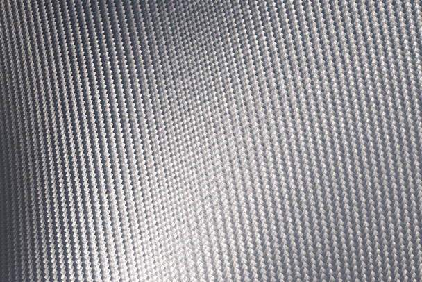 Detailní záběr na povrch z šedých uhlíkových vláken. Struktura a vzor pozadí. Moderní technologie a koncepce materiálu. - Fotografie, Obrázek
