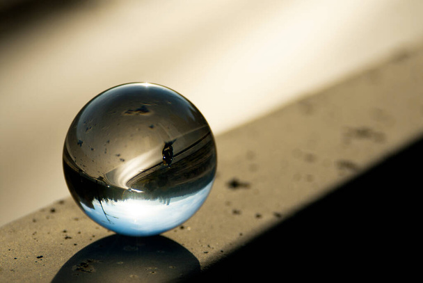 A highway view through a lens ball. Glass ball with inverted street view. Lens ball photography. - Foto, Bild