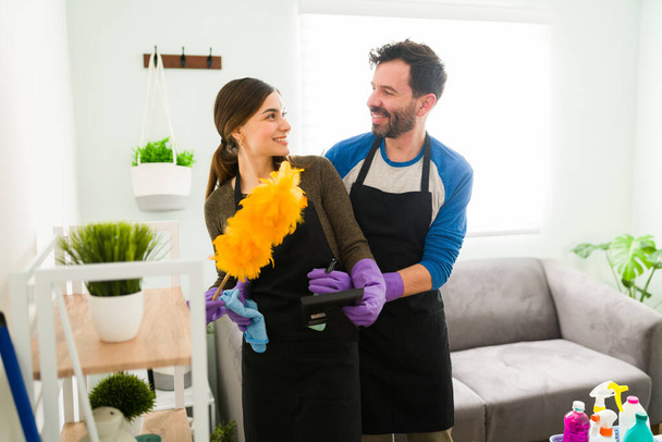 Good looking Hispanic couple embracing each other face to face while doing all the housework together and having a good time - Φωτογραφία, εικόνα