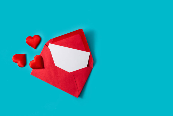 Hearts coming out of an red envelope on blue background - 写真・画像