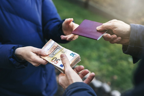 identity and travel document fraud - person buying illegal fake passport - Foto, Bild