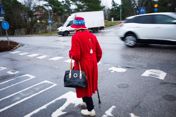 Stockholm, Schweden Eine Seniorin geht über einen Zebrastreifen. - Foto, Bild