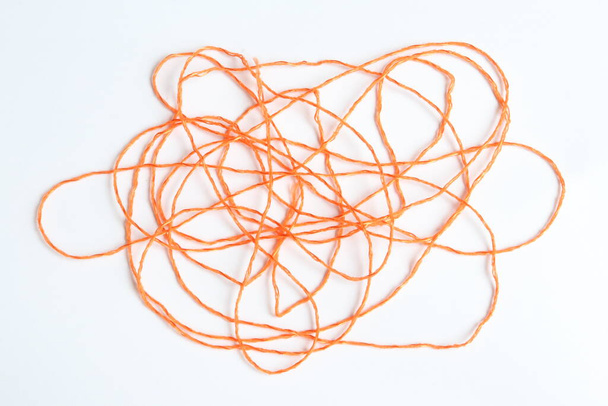 Orange thread on a piece of paper. - Photo, Image