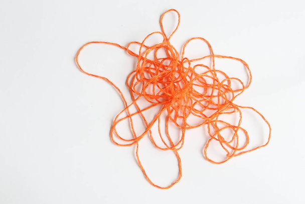 Orange thread on a piece of paper. - Photo, Image