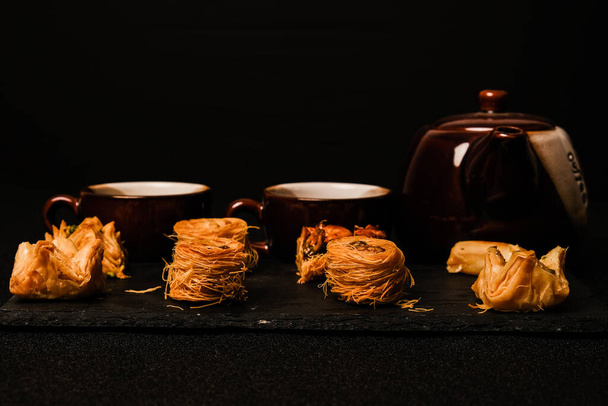 A low key picture of Arabic Baklava serve with Arabic Coffee. - Photo, Image