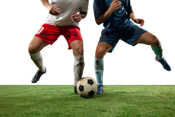 Close up legs of professional soccer, football players fighting for ball on field isolated on white background - Fotoğraf, Görsel