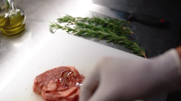 Cooking beef steak at home, Beef fillet on the Cut Board, Juicy steak with grilling stripes, chef put rosemary on meat - Footage, Video