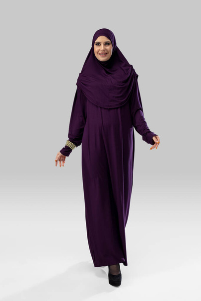 Beautiful arab woman posing in stylish hijab isolated on studio background. Fashion concept - Foto, Imagem