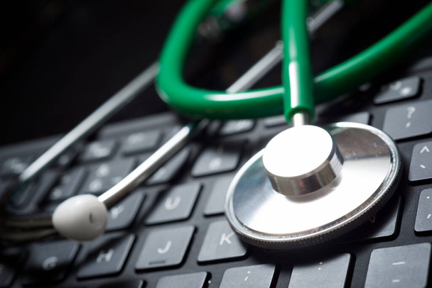 Stethoscope on the keyboard of a laptop. - Photo, Image