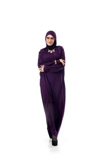Beautiful arab woman posing in stylish hijab isolated on studio background. Fashion concept - Foto, afbeelding