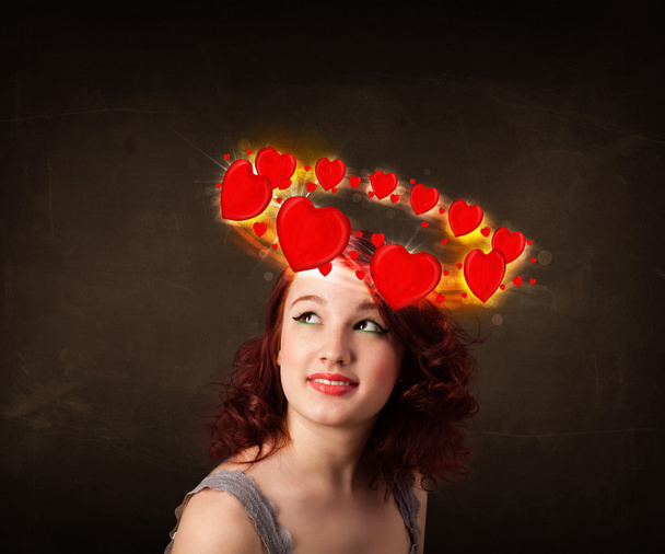 teenager girl with heart illustrations circleing around her head - Foto, afbeelding