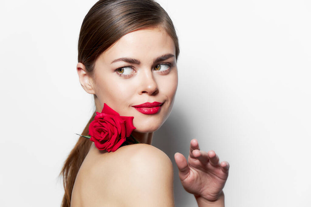 Portrait of woman with rose Looks aside red lips luxury charm - Photo, Image