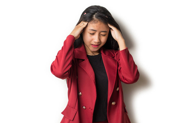 portrait of stressed sick business woman with headache; ill woman suffers from vertigo, dizziness, migraine, hangover, health care concept; young adult asian woman model - Photo, Image