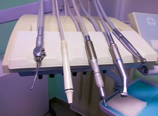 Different dental instruments and tools in a abstract dentists office - Photo, Image