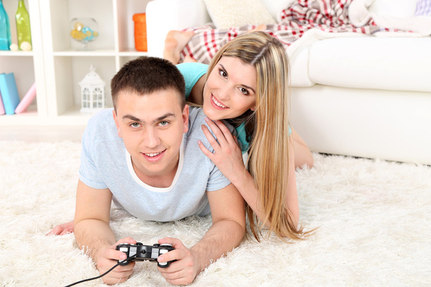 Couple playing video games on home interior background - Fotoğraf, Görsel
