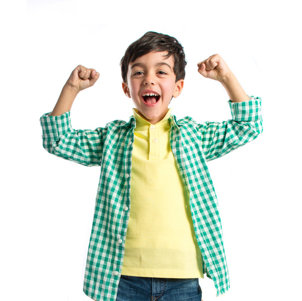 Lucky brunette kid over isolated white background  - Photo, Image