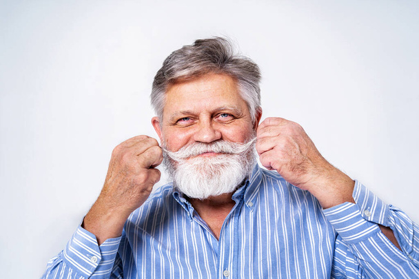 Eccentric senior man with funny expression portrait on background - Active and youthful old male - Zdjęcie, obraz
