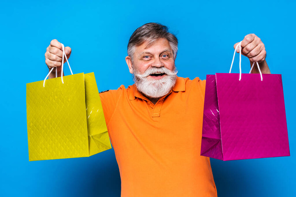Eccentric senior man with funny expression portrait on background - Active and youthful old male - 写真・画像