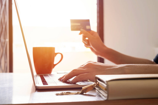 Hands holding credit card and using laptop. Online shopping - Φωτογραφία, εικόνα
