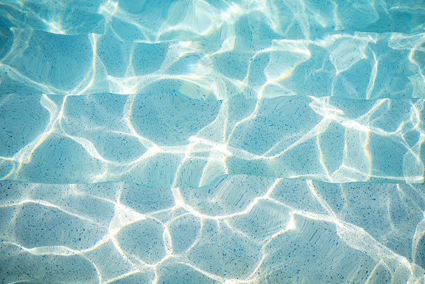 Ripple Water in swimming pool with sun reflection - Foto, imagen