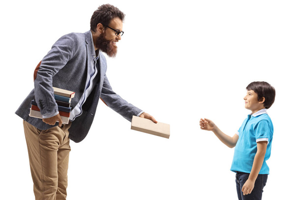 Man giving a book to a boy isolated on white background - Φωτογραφία, εικόνα