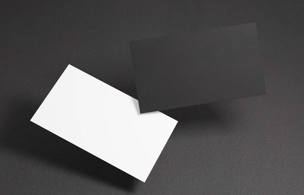 Tarjeta de visita flotante Mockup. Primer plano en dos tarjetas de visita vacías flotando en el aire frente al fondo negro - Foto, Imagen