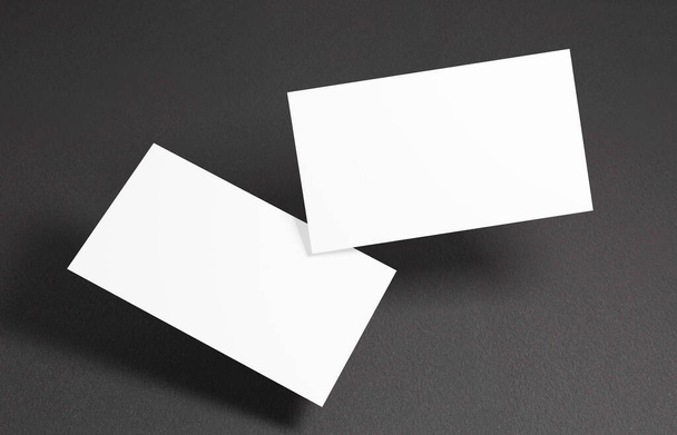 Плавающий макет визитной карточки. Крупный план на двух пустых визитках, плавающих в воздухе перед черным фоном - Фото, изображение