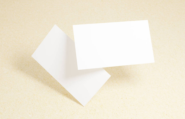 Floating Business Card Mockup. Closeup on two empty business cards floating in the air in front of the cardboard background - Photo, Image
