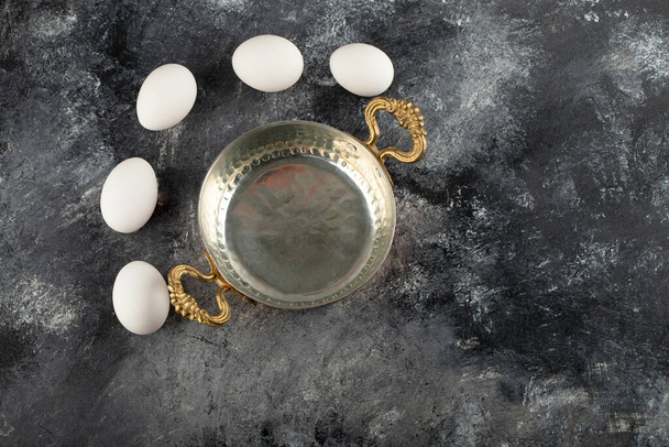 Some of white raw chicken eggs with saucepan - Zdjęcie, obraz