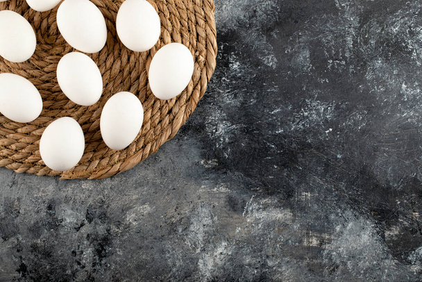 Some of white raw chicken eggs on a sackcloth - Foto, Imagen