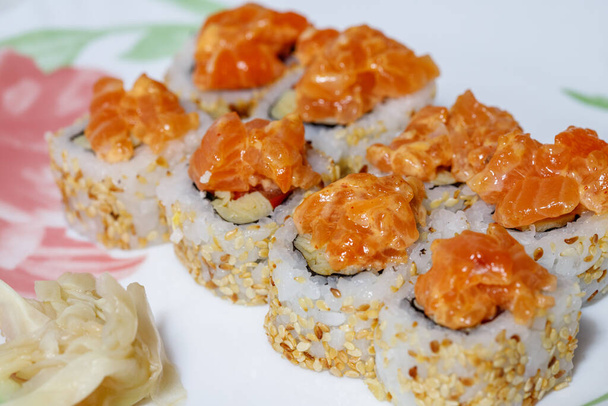 Sushi and rolls home delivery. Krpny plan. Sesame, salmon, cheese. - Photo, Image