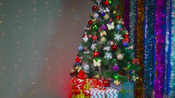 Weihnachtsbaum Geschenke und Dekorationen auf dem Hintergrund mit blinkenden Glühbirnen - Filmmaterial, Video