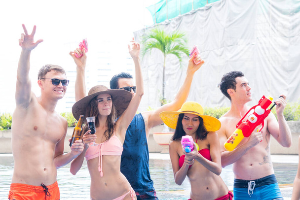 Group of Young sexy body People  having Fun at Poolside. Happy Friends Enjoying Pool Party. Summer Vacation Concept - Photo, Image