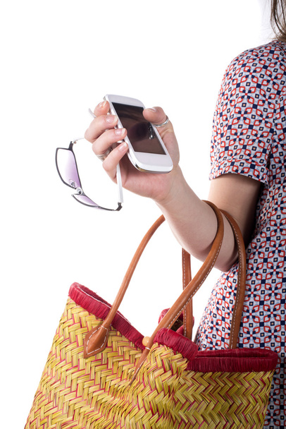 νέα γυναίκα που κρατά ένα καλάθι και ένα κινητό τηλέφωνο - Φωτογραφία, εικόνα