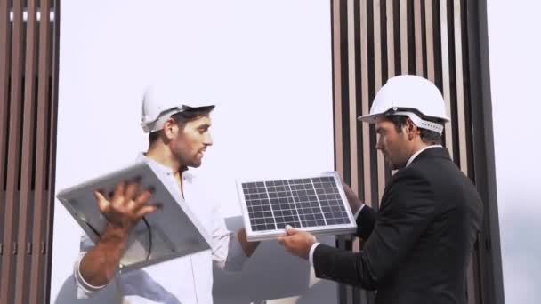 Engineers man comparing of efficiency Solar Panel Concept of Renewable Energy Working. Specialists Gathered for Outdoor testing Photovoltaic cells module. - Footage, Video