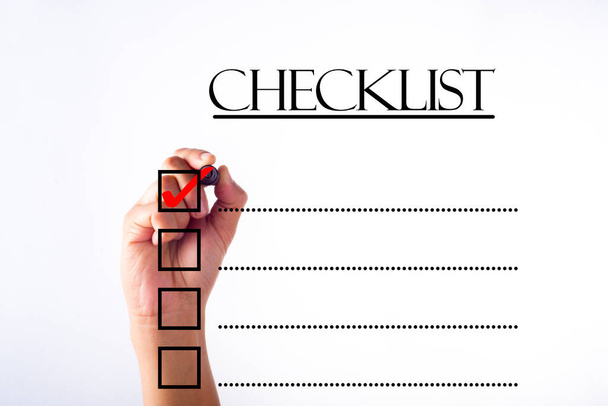 Businessman checking mark on checklist with marker over white - Photo, Image