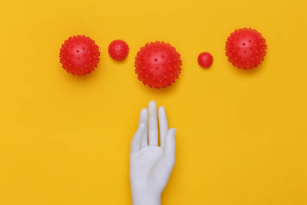 Mannequin hand and virus strain on yellow background. Covid-19. Top view - Foto, Imagen