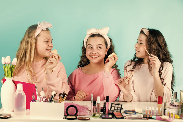 little sisters in retro fashion headscarf. makeup for kids. group of happy friends at spa. friendship party with cosmetic. relax and having fun. small girls in beauty salon. Young and beautiful - Фото, изображение